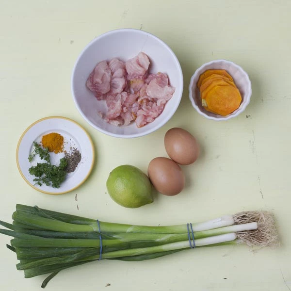 Zutaten: Fischstücke, Süßkartoffel, Frühlingszwiebel, Eier, Limette und Gewürze.